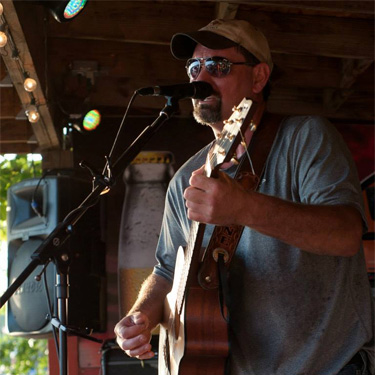 Jeff Stike playing guitar and singing at Fall Fest a few years back